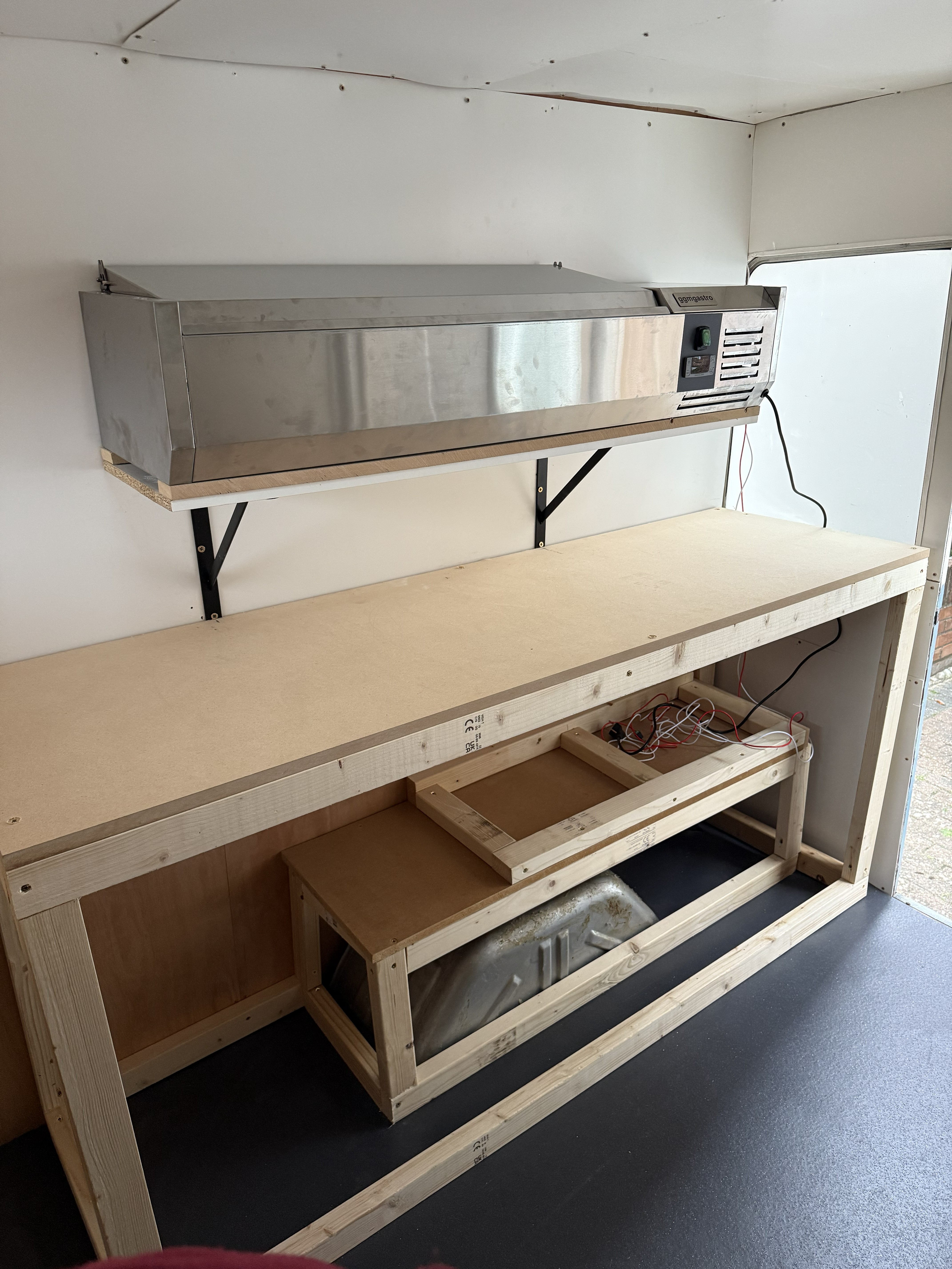 Topping fridge fitting with battery holders underneath